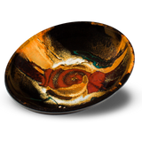 9-inch wheel-thrown stoneware bowl in toasted orange and red colors set against a black background. Handmade pottery by Prairie Fire Pottery. Hand made in the U.S.A.  3/4 tabletop view.