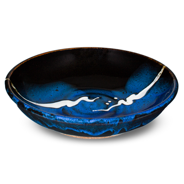 9 inch handmade pottery bowl in cobalt blue and black colors.  Hand made by Prairie Fire Pottery.  3/4 view.
