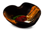 Heart-shaped bowl in toasted orange and black with red accents. Handmade pottery by Prairie Fire Pottery.  3/4 view.