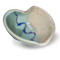 Handmade pottery Heart Bowl in turquoise & white with blue accent.  Side 3/4 view.