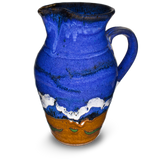 52 ounce wheel-thrown pitcher in cobalt blue and toasted brown.  Handmade pottery by Prairie Fire Pottery.  Hand made in stoneware clay and high-fired to 2400°.  Left side view.