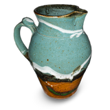 60 ounce wheel-thrown pitcher in turquoise and brown colors.  Handmade pottery crafted in stoneware clay by Prairie Fire Pottery.  Left side view.