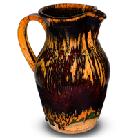52 ounce handmade pottery pitcher in earth tones and red.  Wheel-thrown pottery fired to 2400° for strength and durability.  Hand made by Prairie Fire Pottery in the U.S.A.  Left side view.