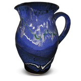 56 ounce handmade pottery pitcher in cobalt blue and black.  Wheel-thrown stoneware clay.  Hand made by Prairie Fire Pottery.  Right side view.