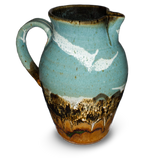 56 ounce high-fired wheel-thrown pitcher in turquoise and brown colors.  It is handmade pottery by Prairie Fire Pottery.  Hand made in stoneware clay.  Left side view.