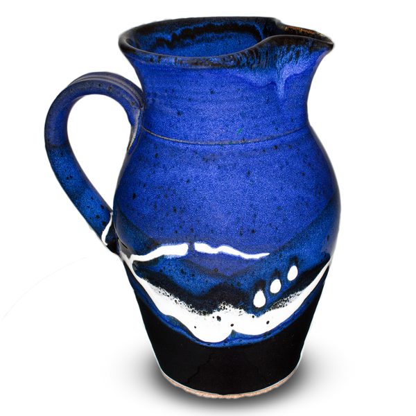 Beautiful blue and black handmade pottery pitcher.  Capacity 56 ounces. Hand made and high-fired by Prairie Fire Pottery.  Left side view.