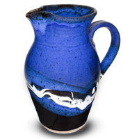 Beautiful blue and black handmade pottery pitcher. Capacity 56 ounces. Hand made and high-fired by Prairie Fire Pottery. Right side view.