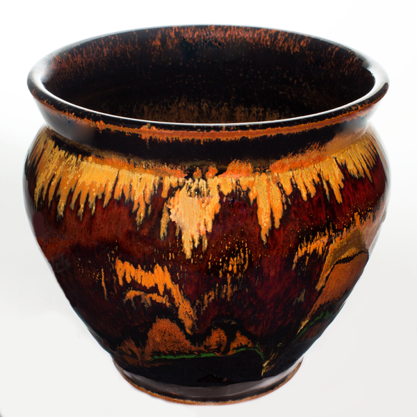 Radiant earth tone and red colors on a 7 inch handmade pottery spoon crock.  Hand made by Prairie Fire Pottery.