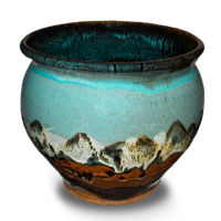 Soft turquoise and brown colors on a 7 inch handmade pottery spoon crock. Hand made by Prairie Fire Pottery. Hand crafted in stoneware clay and made in the U.S.A.