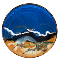 Handmade pottery platter.  14-inch diameter.  Beautifully glazed in cobalt blue, toasted orange, and black.  Hand made in stoneware clay by Prairie Fire Pottery.  Overhead view.