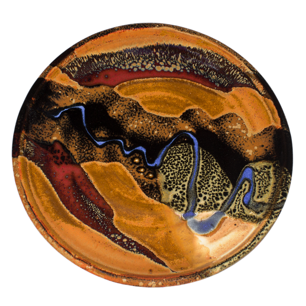 8 inch handmade pottery plate in earth tone colors accented with a meandering blue line.  Hand made in stoneware clay by Prairie Firee Pottery.  Overhead view.