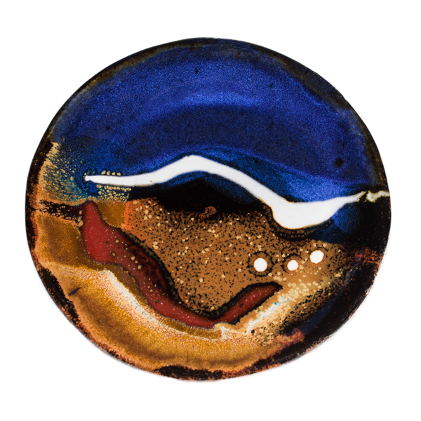 Cobalt blue and toasted brown colors on a 4 inch handmade pottery plate.  Hand made by Prairie Fire Pottery from stoneware clay.  Overhead view.