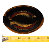 4.5 inch small plate in red and black colors.  Handmade pottery by Prairie Fire Pottery.  3/4 view with ruler.