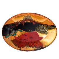 This is a 9-inch oval plate in beautiful earth tone colors accented with red. It is high-fired stoneware clay. Handmade pottery by Prairie Fire Pottery. Hand made in the U.S.A.  Overhead view.