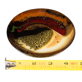 Small round plate in beautiful earth tone colors and red.  It's handmade pottery by Prairie Fire Pottery.  Hand crafted in stoneware clay and high-fired to 2400°.   Side view with ruler.