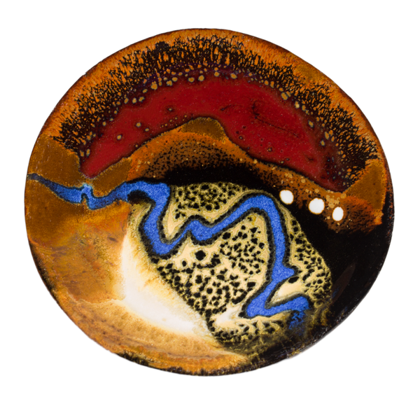 Small handmade pottery plate in earth tones and red, accented with a meandering ribbon of blue.  Hand made by Prairie Fire Pottery in stoneware clay.  Overhead view.