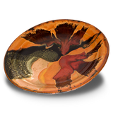Stoneware serving platter. 14 inch diameter. Beautiful colors, toasted orange, red, and black. Handmade pottery by Prairie Fire Pottery. Hand made in the U.S.A.   3/4 view.
