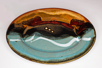 Turquoise, brown, and red colors on a 9 inch oval plate.  Handmade pottery by Prairie Fire Pottery.