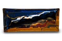 This is high-fired stoneware by Prairie Fire Pottery. It is a 12 1/2 inch rectangular plate in a beautiful blend of cobalt blue, toasted brown, and red. It is hand made and kiln-fired to 2400°. Made in the U.S.A. Overhead view.