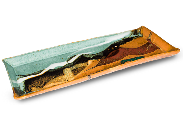 Turquoise-brown rectangular tray.  12 1/2 inches long.  Handmade pottery by Prairie Fire Pottery.  Hand made in the U.S.A.  High-fired stoneware clay.   This is the 3/4 table top view.